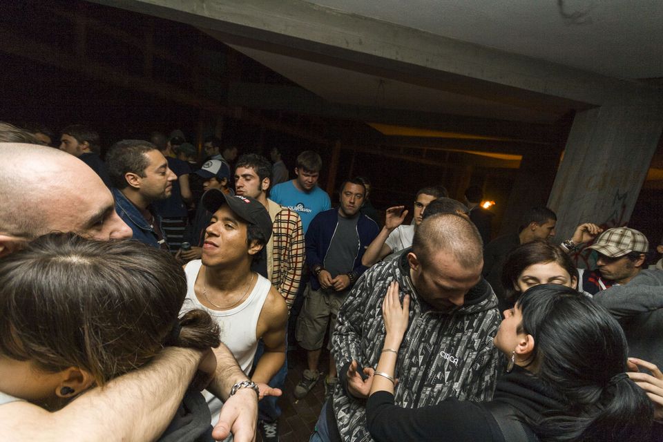 Packed crowd of partygoers close together in low light