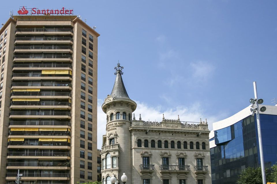Corner tower of a stone building beside a tall block