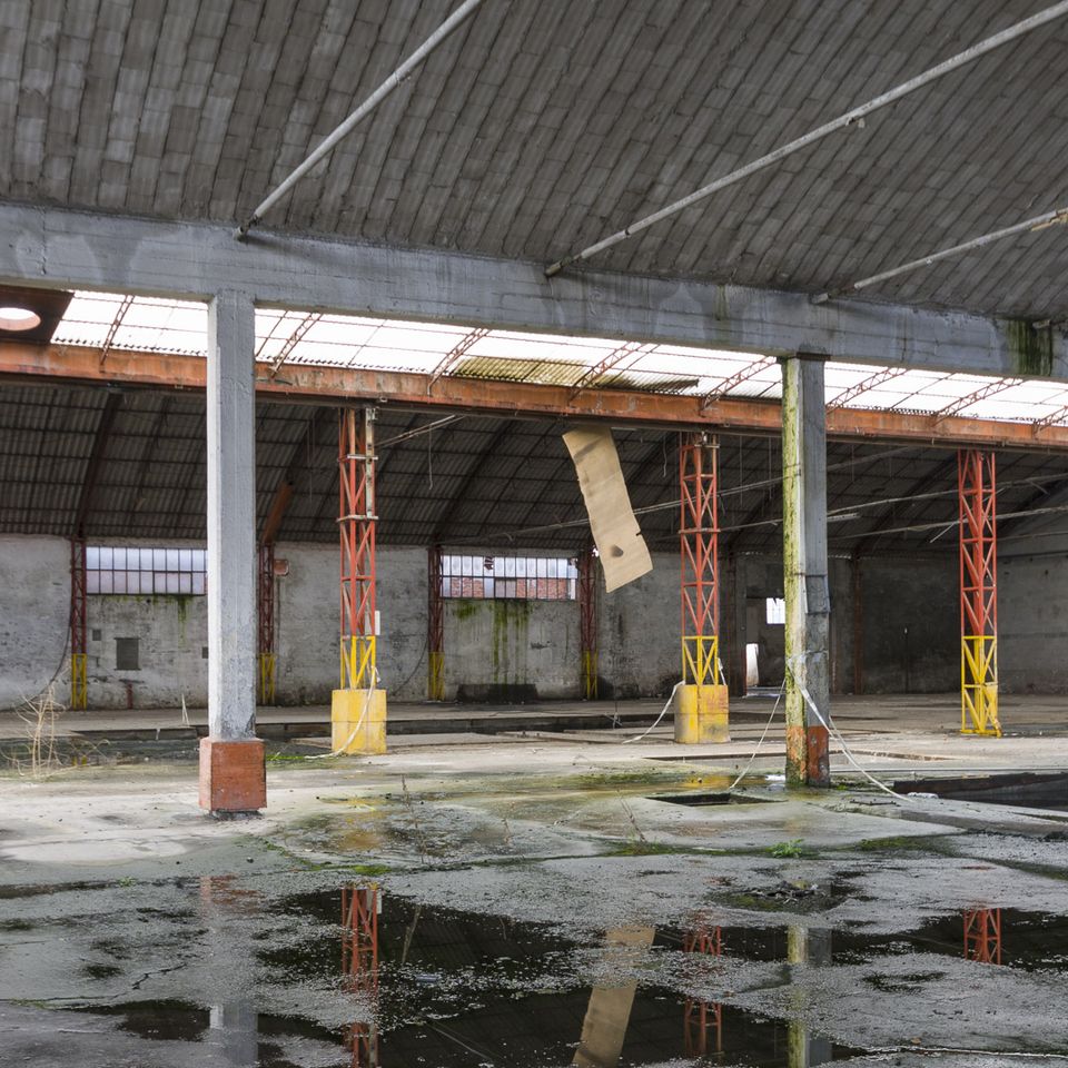 Hall with red and yellow columns above a waterlogged floor