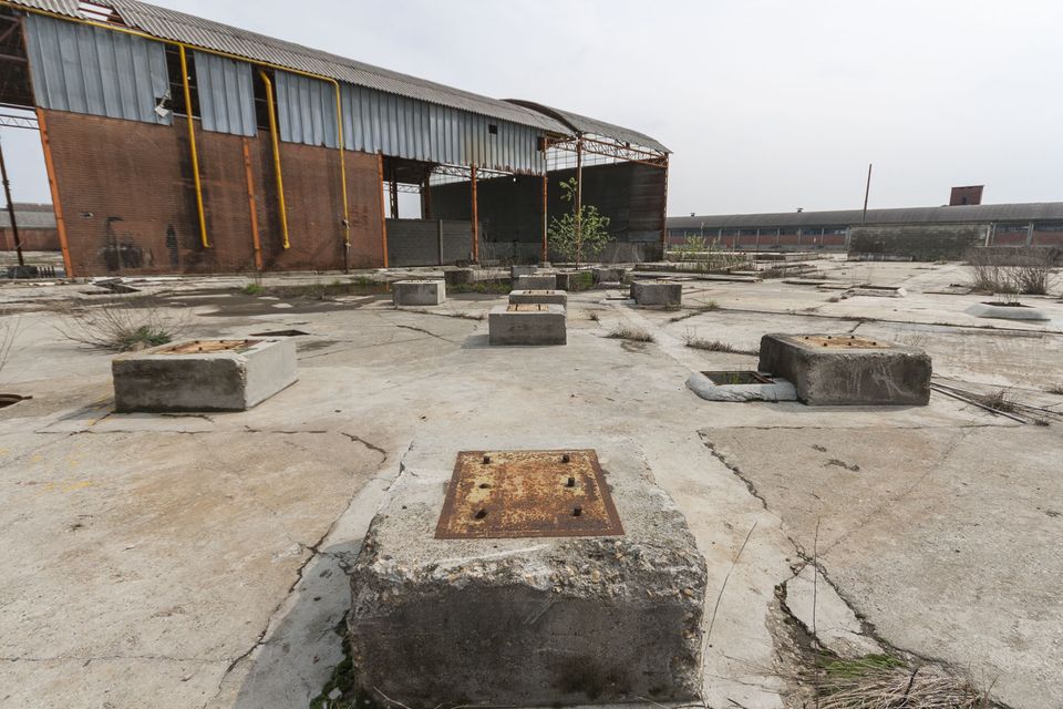 Concrete machine bases scattered across a cracked yard