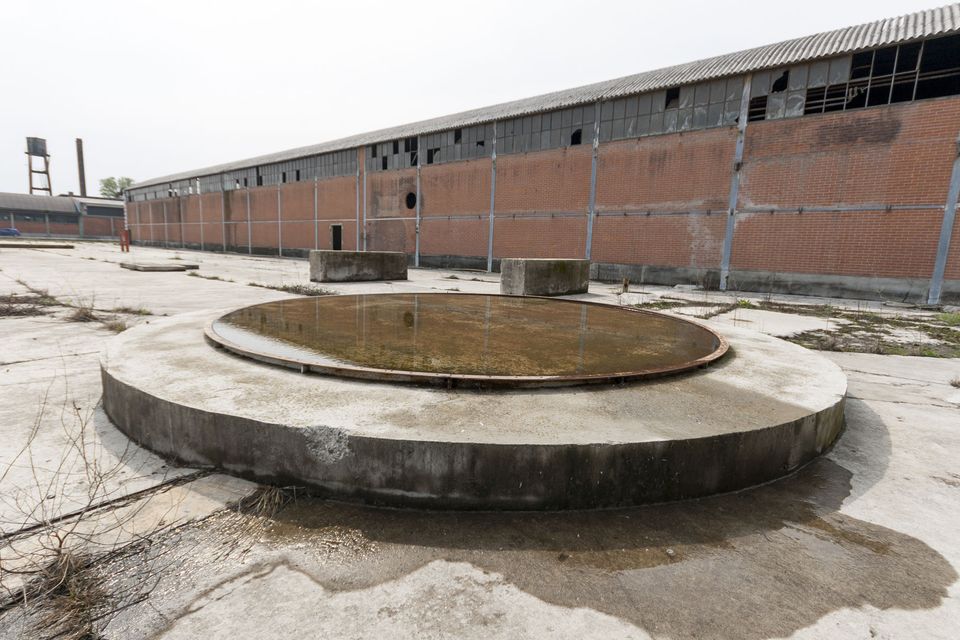 Circular concrete basin holding a shallow pool of water