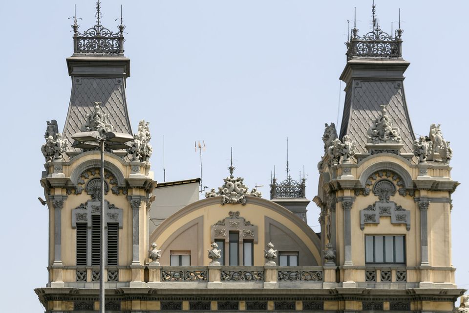 Ornate twin towers with slate spires and carved stone details