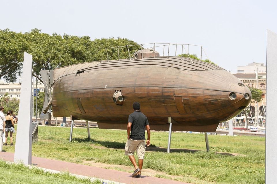 Early submarine with a wooden hull displayed on a lawn