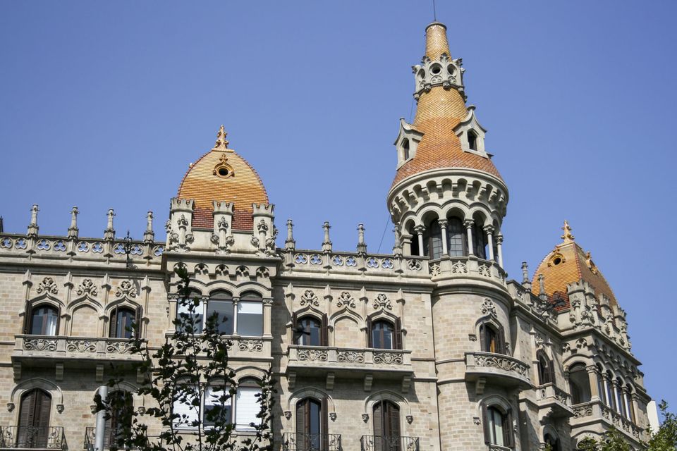 Ornate corner building with orange-tiled domes and towers