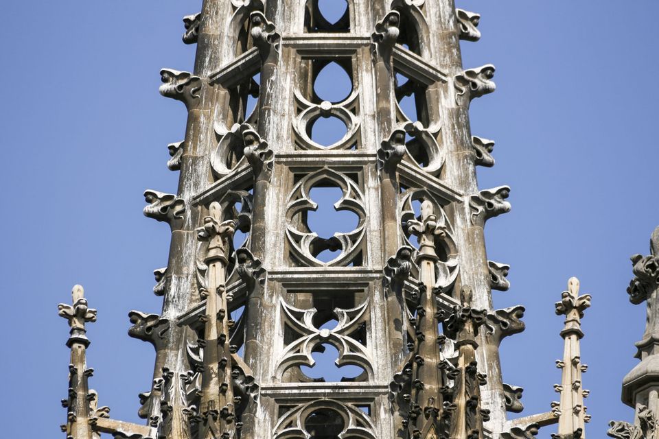 Openwork Gothic spire with pinnacles against blue sky