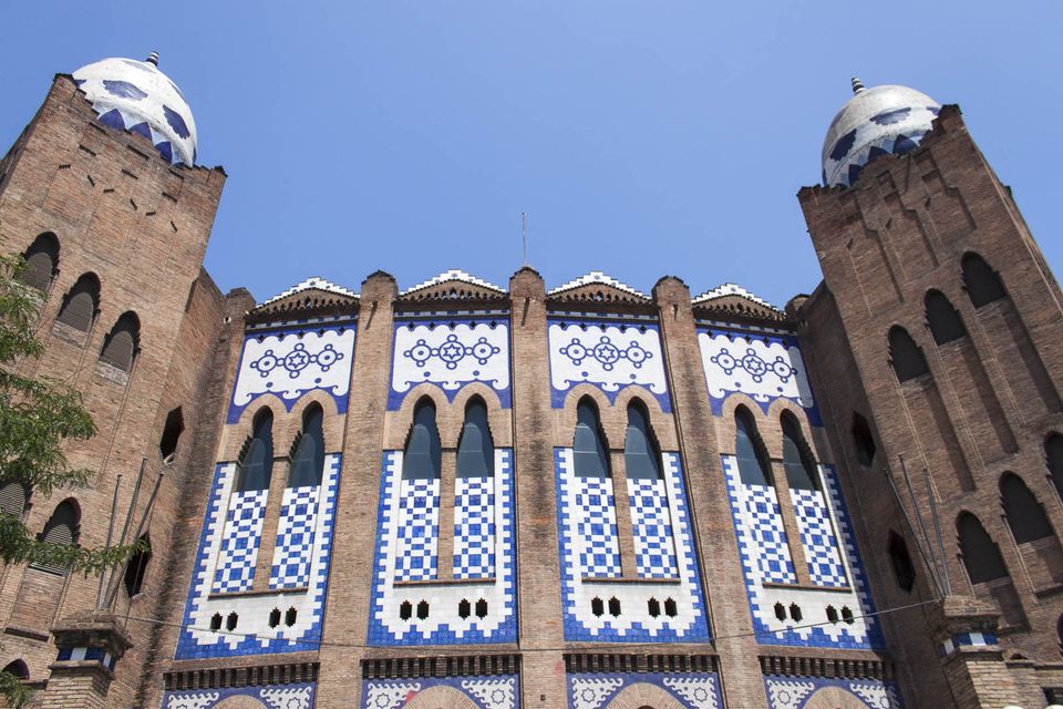 Blue and white tiled brick facade with domes on a bullring