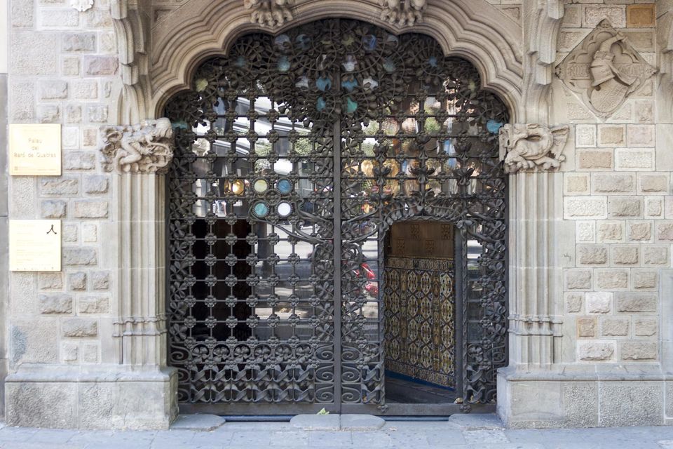 Wrought-iron gate in a carved stone doorway