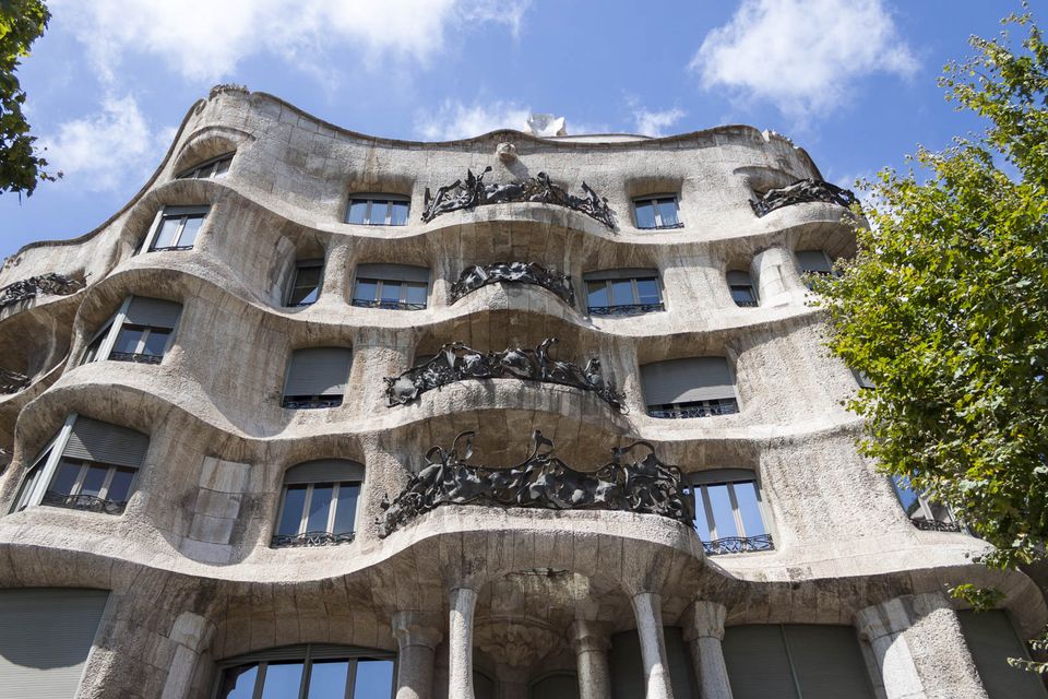 Wavy stone facade of Casa Milà with wrought-iron balconies