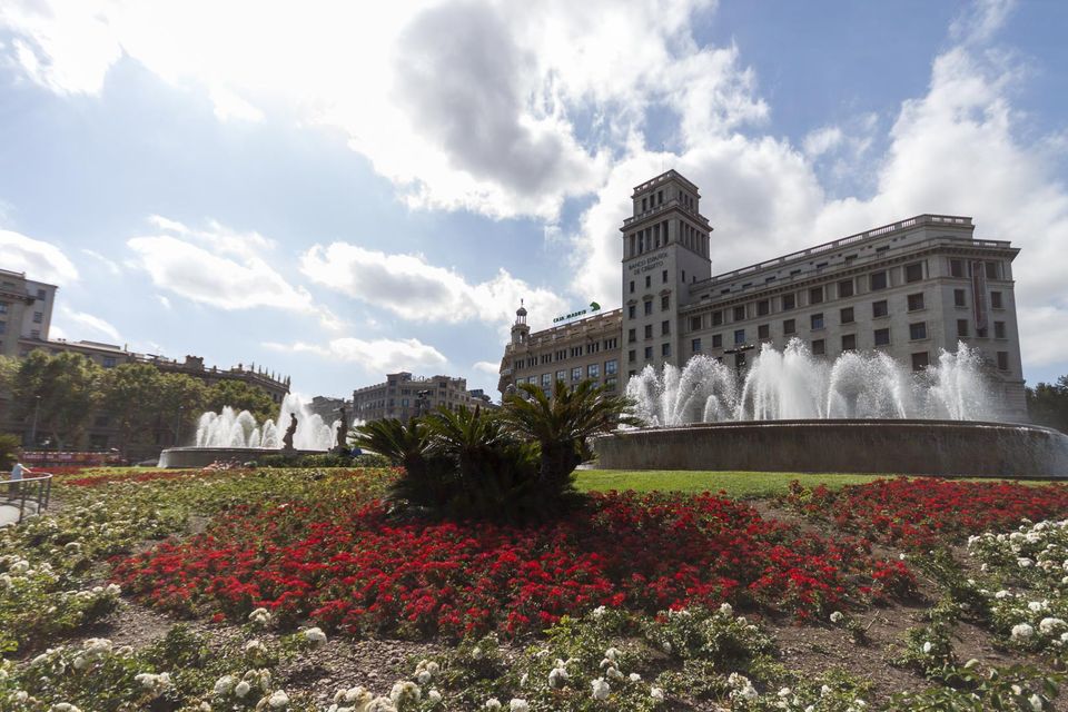 Fountains and red flower beds in a sunny plaza