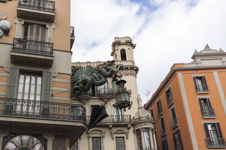 Dragon and umbrella on a corner building facade
