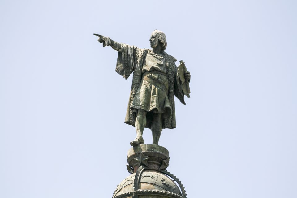 Bronze statue pointing out to sea atop a column