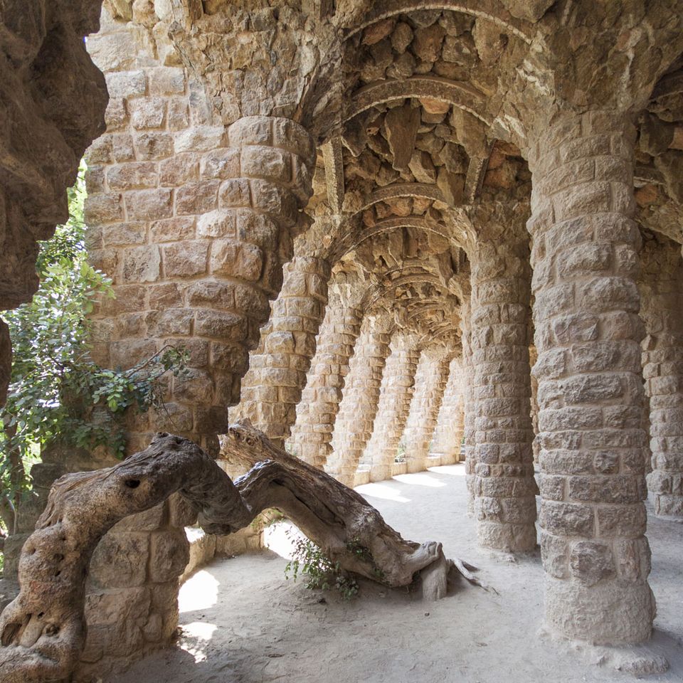 Colonnade of leaning rough stone columns in a park