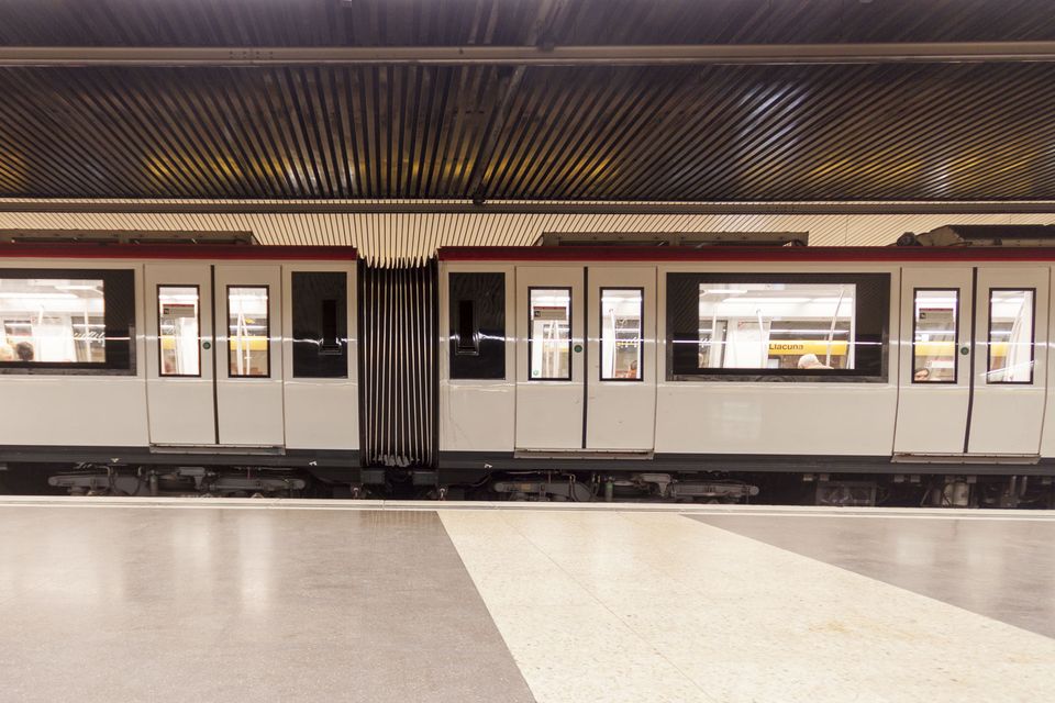 Metro train standing at an empty platform