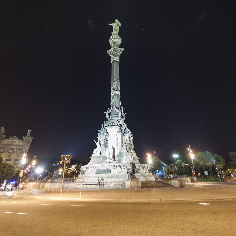 Columbus monument lit against the night sky
