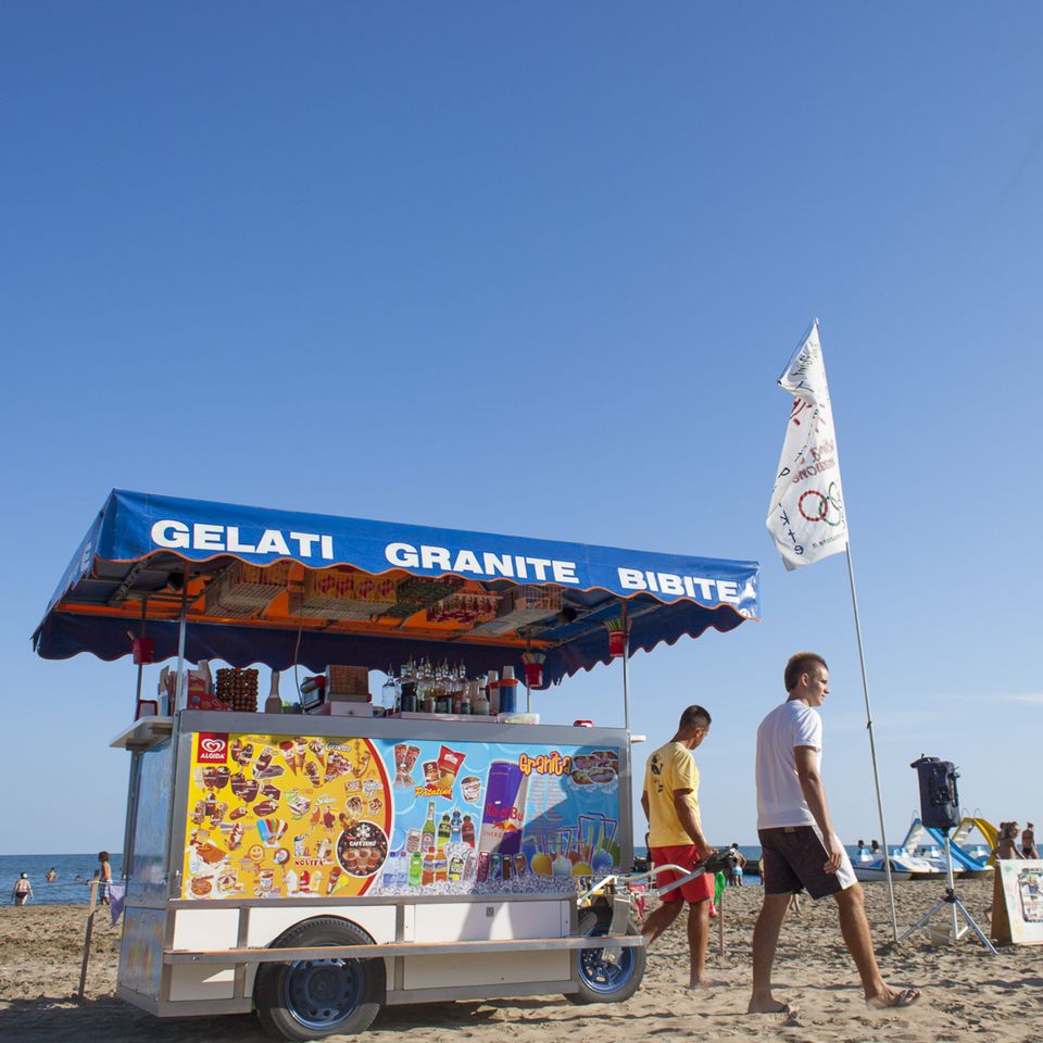 Ice cream and granita cart on the beach under a blue sky