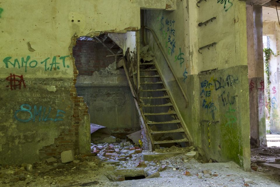 Staircase and graffiti-covered walls in a ruined building