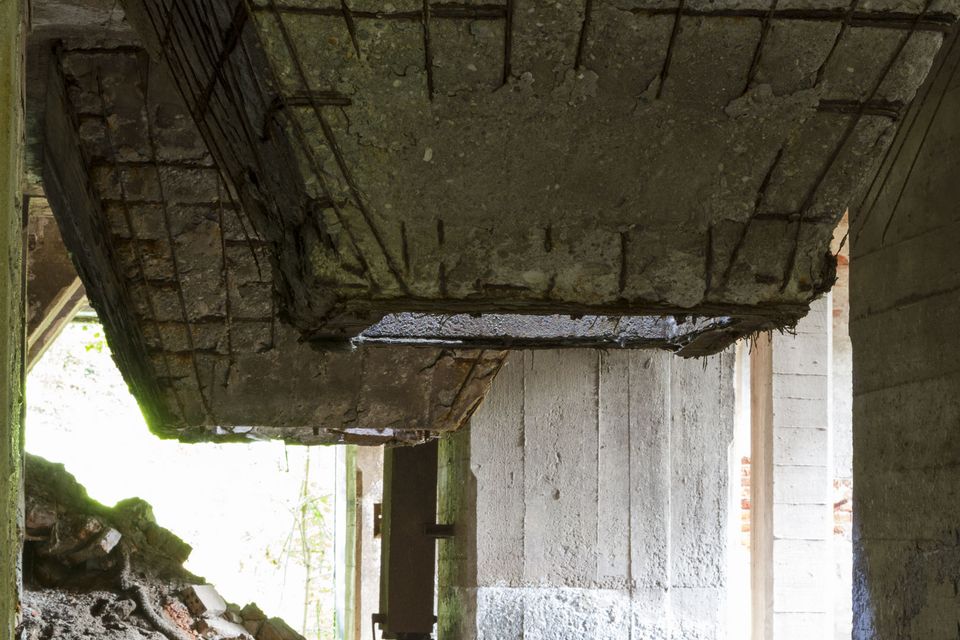 Concrete slab and beams collapsing above a doorway