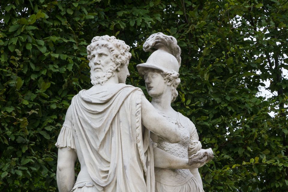 White marble statues of a bearded man and a helmeted woman