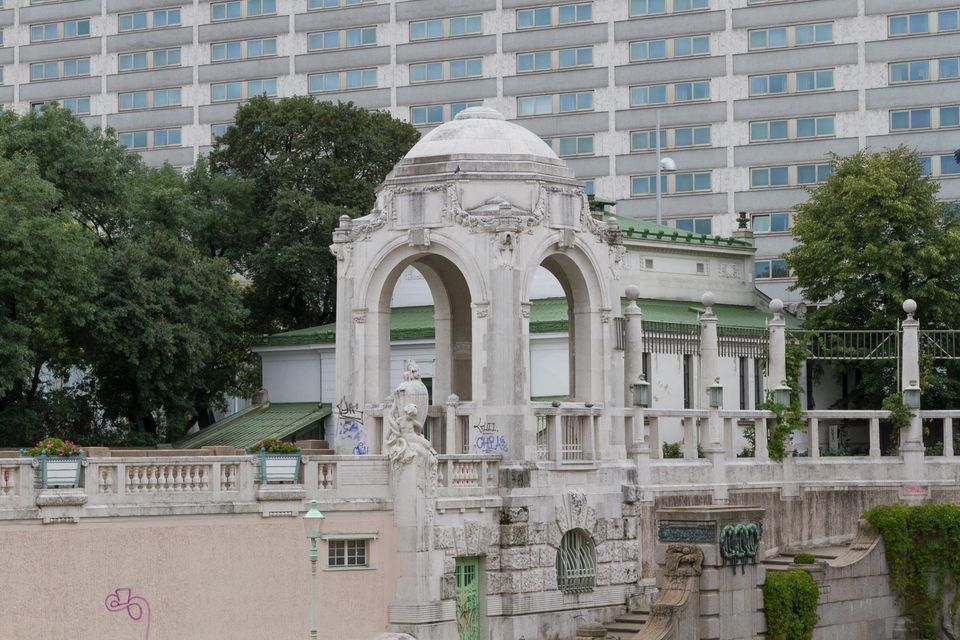 Art Nouveau stone arcade with a domed pavilion and graffiti