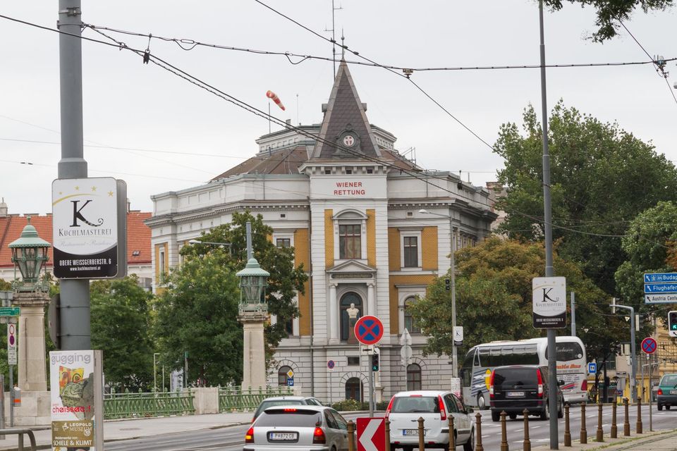Corner building with a pointed turret and a rescue service sign