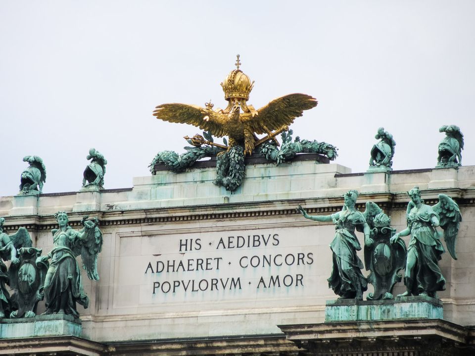 Golden double-headed eagle between green bronze figures