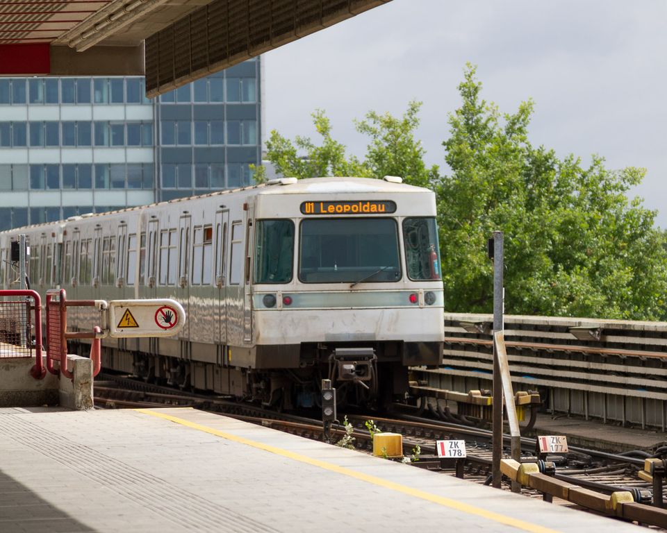 Metro train marked Leopoldau arriving at an open-air platform