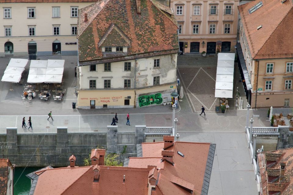 Riverside square with café umbrellas seen from above