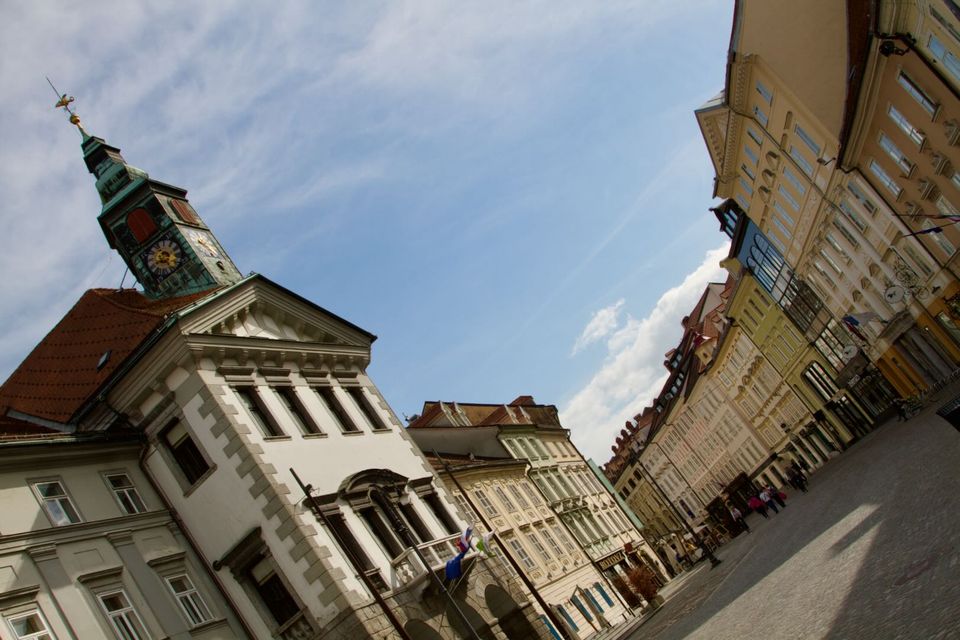 Town Hall clock tower and old facades seen at a tilted angle