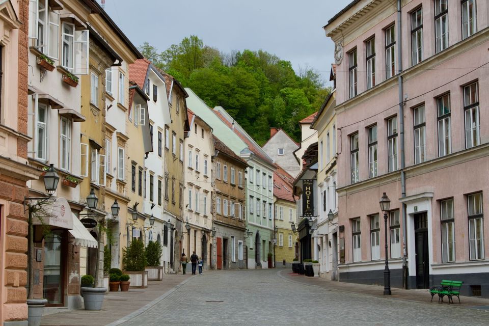 Old town street lined with pastel facades and cobbles