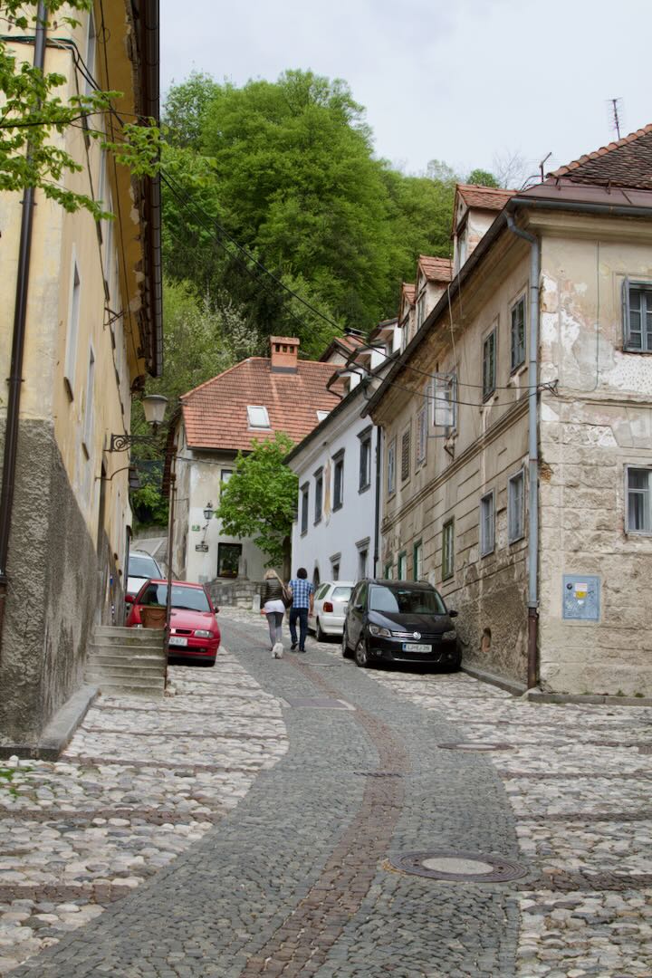 Steep cobbled street climbing towards the castle hill