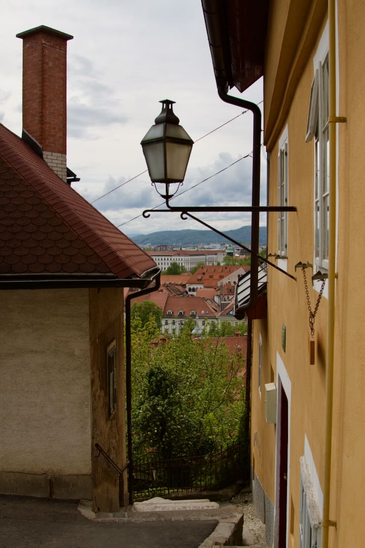Street lamp on a wall in a narrow alley