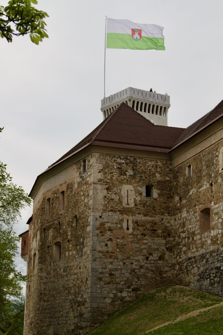 Castle watchtower flying the green and white city flag