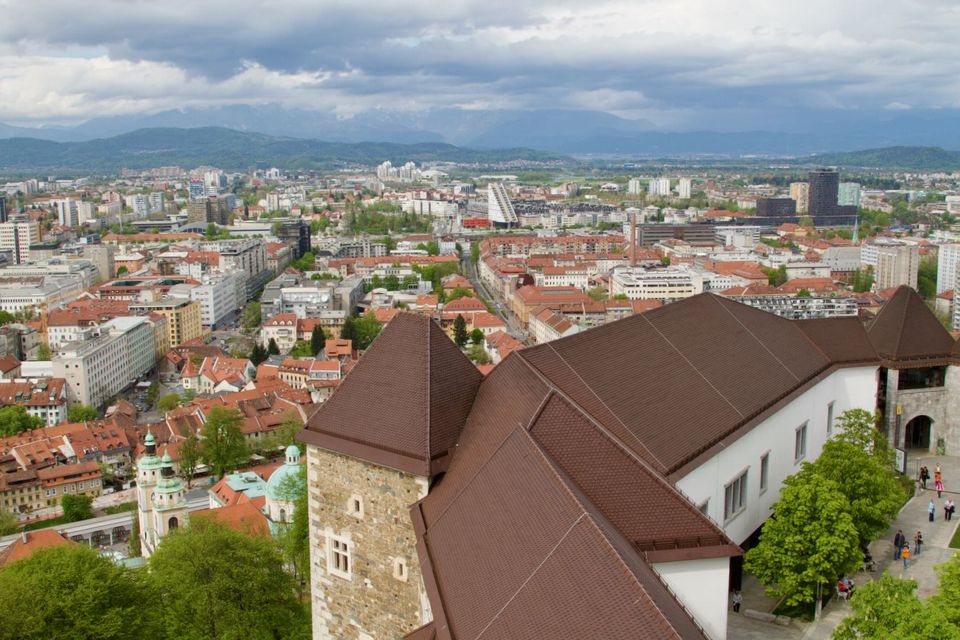 Castle walls above the city with the mountains in the distance