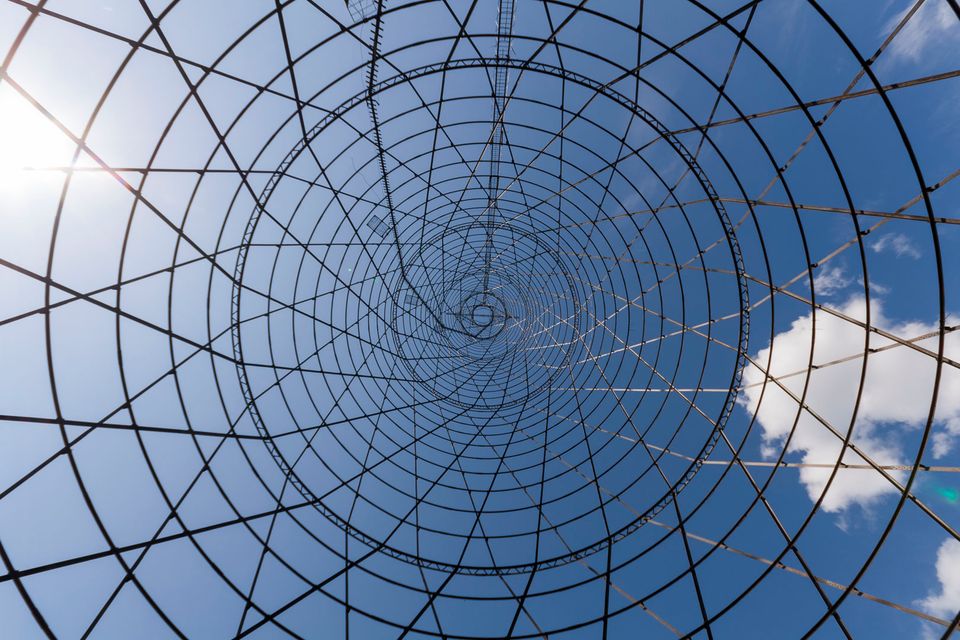 Looking up inside the tower’s spiderweb of steel rings and rods