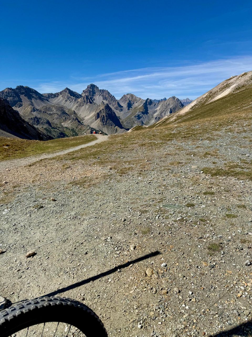 Front wheel on a stony slope, jagged peaks on the horizon