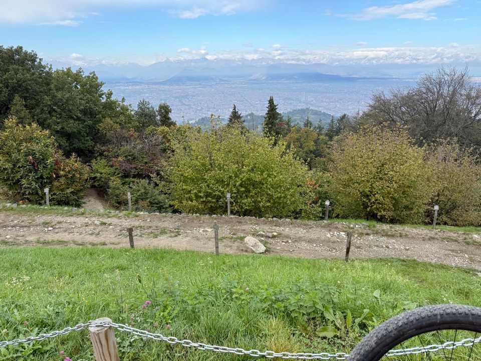 Meadow and chain fence above Turin, the Alps on the horizon